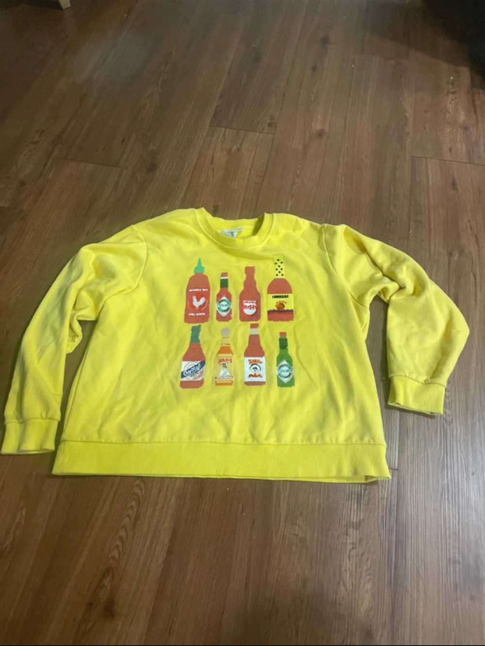 QUEEN OF SPARKLES Yellow Crewneck Sweatshirt with Bottle Graphic